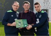 5 October 2016; Republic of Ireland manager Martin O'Neill and Seamus Coleman with Sportsfile photographer David Maher, centre, with Sportsfile's new book, The Republic of Ireland at Euro 2016 - A Pictorial Record, following squad training at the FAI National Training Centre in Abbotstown, Dublin. Remember the excitement of Euro 2016 when the Boys in Green did the country proud? As Christmas approaches the Sportsfile photographic team has compiled a 54-page photographic record of those memorable June days in France. All the goals are included and naturally there are also some great pictures of well-behaved Irish supporters as they did their bit for Ireland of the Welcomes. All the action and fans zone celebrations have now been brought together in a beautifully illustrated book titled The Republic of Ireland at Euro 2016. From Wes Hoolahan’s brilliant strike in the opening game against Sweden in Paris to Bordeaux and a 3-0 defeat to Belgium. Then Robbie Brady’s perfectly timed header as Martin O’Neill’s team beat Italy in Lille to progress to the round of 16, where the dream eventually ended against France in Lyon. With captions by Sean Creedon and supported by CityJet the book is available in book shops and online at http://www.sportsfile.com . (€14.95 plus postage and packaging).  Photo by Seb Daly/Sportsfile