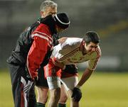 26 January 2011; Sean Cavanagh, Tyrone in discomfort being attended to by physio Michael Harte. Barrett Sports Lighting Dr. McKenna Cup Section A, Fermanagh v Tyrone, Brewster Park, Enniskillen, Co. Fermanagh. Picture credit: Oliver McVeigh / SPORTSFILE