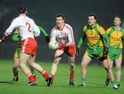 19 February 2011; Enda McGinley, Tyrone, passes the ball off to Aidan McCrory, under pressure from Michael Murphy, Donegal. Allianz Football League, Division 2 Round 2, Tyrone v Donegal, Healy Park, Omagh, Co. Tyrone. Picture credit: Oliver McVeigh / SPORTSFILE