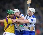 20 February 2011; Keith Rossiter, Wexford, is tackled by Stephen Molumphy and Richie Foley, Waterford. Allianz Hurling League, Division 1 Round 2, Wexford v Waterford, Wexford Park, Wexford. Picture credit: Matt Browne / SPORTSFILE
