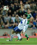8 October 2016; Conor Washington of Northern Ireland with a shot on goal despite the tackle of Marco Berardi of San Marino during the FIFA World Cup Group C Qualifier match between Northern Ireland and San Marino at Windsor Park in Belfast. Photo by Oliver McVeigh/Sportsfile