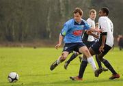 21 February 2011; Brian O'Brochlain, UCD, puts the ball past Chinedum Arize, Royal College of Surgeons, despite his tackle. Dublin Bus Collingwood Cup 2011, UCD v Royal College of Surgeons, Dublin University, Santry Avenue, Dublin. Picture credit: Barry Cregg / SPORTSFILE