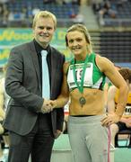 20 February 2011; Kelly Proper, Ferrybank AC, Waterford, is presented with her medal for winning the Women's 200m by Peter Dolan, Marketing Manager, Woodies DIY. AAI Senior Indoor Athletics Championship, Odyssey Arena, Belfast, Co. Antrim. Picture credit: Brendan Moran / SPORTSFILE