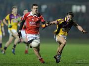 23 February 2011; Andy McDonnell, Louth, in action against Conor Carty, Wexford. Cadbury Leinster Under 21 Football Quarter-Final, Wexford v Louth, Belfield, Enniscorthy, Co. Wexford. Picture credit: Matt Browne / SPORTSFILE