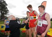 16 February 2011; Liam Hennessy, President Athletics Ireland, presents Kevin Dooney, CBC Monkstown, with his first place medal following the Senior Boys event at the Aviva Leinster Schools Cross Country. Santry Demesne, Santry, Dublin. Picture credit: Stephen McCarthy / SPORTSFILE
