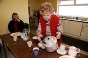 27 February 2011; Stalwart Longford supporter and tea lady Philomena Donoghue fills cups of tea for the match officials during the half-time break. Allianz Football League, Division 4, Round 4, Longford v Kilkenny, Pearse Park, Longford. Picture credit: Barry Cregg / SPORTSFILE