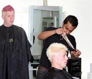 28 February 2011; Ireland's Boyd Rankin is shown his new peroxide look, by his stylist, as his bemused team-mate Kevin O'Brien looks on after they both took part in Today FM's 'Shave or Dye' campaign to raise funds for the Irish Cancer Society. Bounce Salon, Bangalore, India. Picture credit: Barry Chambers / Cricket Ireland / SPORTSFILE