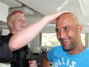 28 February 2011; Ireland's Kevin O'Brien, left, inspects team-mate Andre Botha's new bald look after they both took part in Today FM's 'Shave or Dye' campaign to raise funds for the Irish Cancer Society. Bounce Salon, Bangalore, India. Picture credit: Barry Chambers / Cricket Ireland / SPORTSFILE