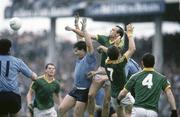 27 July 1986; Mick Lyons, Meath, supported by Terry Ferguson, 7, and Paraic Lyons, 4, punches the ball clear ahead of Joe McNally, Dublin, supported by Leo Close, right. Leinster Senior Football Final, Meath v Dublin, Croke Park, Dublin. Picture credit; Ray McManus / SPORTSFILE