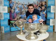 18 October 2016; AIG Insurance, proud sponsor of Dublin GAA, held a reception at its offices today to mark the Dublin football team’s All-Ireland success. Pictured is Bernard Brogan of Dublin with Emily Dunn, age 6 weeks, and Adam Canavan, age 4 month, in the Sam Maguire cup. For more information about AIG Insurance’s products and services go to www.aig.ie or call 1890 50 27 27. AIG Offices in North Wall Quay, Dublin. Photo by Cody Glenn/Sportsfile