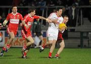 5 March 2011; Sean Cavanagh, Tyrone, in action against Gerard O'Kane and Declan Mullan, Derry. Barrett Sports Lighting Dr. McKenna Cup Final, Tyrone v Derry, Athletic Grounds, Armagh. Picture credit: Oliver McVeigh / SPORTSFILE