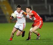 5 March 2011; Brian McGuigan, Tyrone, in action against Barry McGuigan, Derry. Barrett Sports Lighting Dr. McKenna Cup Final, Tyrone v Derry, Athletic Grounds, Armagh. Picture credit: Oliver McVeigh / SPORTSFILE