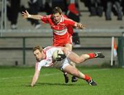 5 March 2011; Aidan Cassidy, Tyrone, in action against Gerard O'Kane, Derry. Barrett Sports Lighting Dr. McKenna Cup Final, Tyrone v Derry, Athletic Grounds, Armagh. Picture credit: Oliver McVeigh / SPORTSFILE