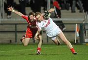 5 March 2011; Aidan Cassidy, Tyrone, in action against Gerard O'Kane, Derry. Barrett Sports Lighting Dr. McKenna Cup Final, Tyrone v Derry, Athletic Grounds, Armagh. Picture credit: Oliver McVeigh / SPORTSFILE