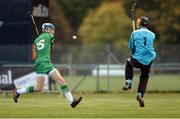 22 October 2016; Jack Sheridan of Ireland scores his side's first goal past Scotland goalkeeper Scott MacLachlan during the 2016 U21 Hurling/Shinty International Series match between Ireland and Scotland at Bught Park in Inverness, Scotland. Photo by Piaras Ó Mídheach/Sportsfile