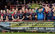 22 October 2016; Scotland captain John Barr celebrates with the cup and his team-mates after the 2016 Senior Hurling/Shinty International Series match between Ireland and Scotland at Bught Park in Inverness, Scotland. Photo by Piaras Ó Mídheach/Sportsfile