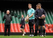 11 March 2011; Ireland's Ronan O'Gara and Jonathan Sexton, watched by head coach Declan Kidney, left, and forwards coach Gert Smal, in action during the squad captain's run ahead of their RBS Six Nations Rugby Championship match against Wales on Saturday. Ireland Rugby Squad Captain's Run, Millennium Stadium, Cardiff, Wales. Picture credit: Barry Cregg / SPORTSFILE