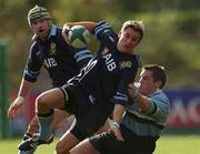 27 October 2001; Brian O'Riordan of UCD supported by Shane Moore, is tackled by Andy Kershaw of Galwegians during the AIB League Division 1 match between UCD and Galwegians at Belfield Bowl in Dublin. Photo by Ray McManus/Sportsfile