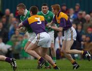 4 November 2001; Aidan Higgins of Charlestown Sarsfields in action against Brian McNella, 3, and Michael Costello, both of Roscommon Gaels, during the AIB Connacht Club Senior Football Championship Semi-final match between Charlestown Sarsfields and Roscommon Gaels at Fr O'Hara Memorial Park in Charlestown, Mayo. Photo by Ray McManus/Sportsfile
