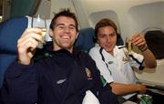 16 November 2001; Republic of Ireland players Kevin Kilbane, left, and Matt Holland celebrate with a glass of champagne on board their return flight to Dublin from Tehran, Iran, after the Republic of Ireland soccer team qualified for the 2002 World Cup Finals in Japan. Photo by David Maher/Sportsfile
