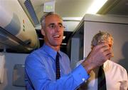 16 November 2001; Republic of Ireland manager Mick McCarthy celebrates with a glass of champagne on board his return flight to Dublin from Tehran, Iran, after the Republic of Ireland soccer team qualified for the 2002 World Cup Finals in Japan. Photo by David Maher/Sportsfile