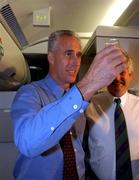 16 November 2001; Republic of Ireland manager Mick McCarthy, celebrates with a glass of champagne on board his return flight to Dublin from Tehran, Iran,  after the Republic of Ireland soccer team qualified for the 2002 World Cup Finals in Japan. Photo by David Maher/Sportsfile