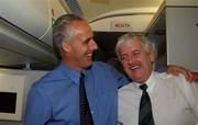 16 November 2001; Republic of Ireland manager Mick McCarthy celebrates with Milo Corcoran, President FAI, on board their return flight to Dublin from Tehran, Iran, after the Republic of Ireland soccer team qualified for the 2002 World Cup Finals in Japan. Photo by David Maher/Sportsfile