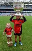 26 October 2016; Holy Trinity SNS, Donaghmede, player Scott Ramsey celebrates with his sister Lilly-Beth, age 3, and the Sam Maguire Cup after beating Our Lady of Good Counsel BNS, Johnstown in the Sciath Corn Chumann na nGael final during the Allianz Cumann na mBunscol Finals at Croke Park in Dublin. Photo by Piaras Ó Mídheach/Sportsfile