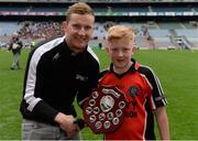 26 October 2016; Holy Trinity SNS, Donaghmede, captain Eóin Kiernan is presented with the shield by Dublin footballer Ciarán Kilkenny after beating Our Lady of Good Counsel BNS, Johnstown in the Sciath Corn Chumann na nGael final during the Allianz Cumann na mBunscol Finals at Croke Park in Dublin. Photo by Piaras Ó Mídheach/Sportsfile