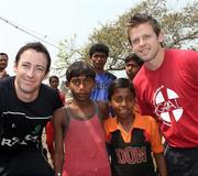 16 March 2011; Ireland cricket players Alex Cusack, left, and Ed Joyce with local children on a team visit to a GOAL project in Kolkata, India. 2011 ICC Cricket World Cup, hosted by India, Sri Lanka and Bangladesh, Kolkata, India. Picture credit: Barry Chambers / Cricket Ireland / SPORTSFILE