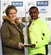 30 October 2016; Dereje Debele Tulu from Ethiopia accepts the Noel Carroll Trophy presented by Anna Livia Murphy of the Carroll family following the SSE Airtricity Dublin Marathon 2016 in Dublin City. 19,500 runners took to the Fitzwilliam Square start line to participate in the 37th running of the SSE Airtricity Dublin Marathon, making it the fourth largest marathon in Europe. Photo by Stephen McCarthy/Sportsfile