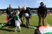 20 March 2011; Members of the Black Knights Parachute Display Team, from left, Private Darren Clarke, Sgt Ray Hennessy, Sgt Padraig Costello, and Sgt Jay Curley, present the match ball to Ireland mascot Calum McCreevy, age 4, from Kilnamanagh, Dublin, after parachuting in to the stadium with the ball. CP Invitational Tournament, St. Patrick's Day Cup Final, Ireland v Holland, Tallaght Stadium, Tallaght, Dublin. Picture credit: Brian Lawless / SPORTSFILE