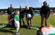 20 March 2011; Members of the Black Knights Parachute Display Team, from left, Private Darren Clarke, Sgt Ray Hennessy, Sgt Padraig Costello, and Sgt Jay Curley, present the match ball to Ireland mascot Calum McCreevy, age 4, from Kilnamanagh, Dublin, after parachuting in to the stadium with the ball. CP Invitational Tournament, St. Patrick's Day Cup Final, Ireland v Holland, Tallaght Stadium, Tallaght, Dublin. Picture credit: Brian Lawless / SPORTSFILE