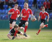 23 March 2011; Colm Driver of CUS goes past the tackle of Graham Burns of Newbridge College during the Vinnie Murray Cup Final match between CUS and Newbridge College at Donnybrook Stadium in Donnybrook, Dublin. Photo by Matt Browne / SPORTSFILE