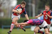 26 March 2011; Cian Aherne, UL Bohemians, is tackled by Erwann Legendre, Clontarf. Ulster Bank League Division 1B, Clontarf v UL Bohemians, Castle Avenue, Clontarf, Dublin. Picture credit: Ken Sutton / SPORTSFILE