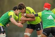 29 March 2011; Munster's Donncha O'Callaghan is tackled by Denis Leamy, left, and Sam Tuitupou during squad training ahead of their Celtic League match against Leinster on Saturday. Munster Rugby Squad Training, CIT, Bishopstown, Cork. Picture credit: Diarmuid Greene / SPORTSFILE