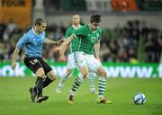 29 March 2011; Keith Treacy, Republic of Ireland, in action against Diego Perez, Uruguay. International Friendly, Republic of Ireland v Uruguay, Aviva Stadium, Lansdowne Road, Dublin. Picture credit: Brian Lawless / SPORTSFILE