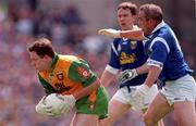 21 June 1998; Adrain Sweeney of Donegal in action against Bernard Morris and Patrick Sheils of Cavan during the Bank of Ireland Ulster Senior Football Championship Semi-Final match between Cavan and Donegal at St Tiernach's Park in Clones, Monaghan. Photo by Matt Browne/Sportsfile