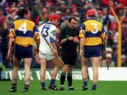 19 July 1998; Clare's Brian Lohan, 3, and Waterford's Michael White, 13, both wearing red helmets are booked by referee Willie Barrett before being sent off during the Guinness Munster Senior Hurling Championship Final Replay match between Clare and Waterford at Semple Stadium in Thurles, Tipperary. Photo by Ray McManus/Sportsfile