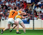 26 July 1998; Killian Farrell of Antrim takes a shot on goal despite the effors from Kieran Kelly of Offaly during the Guinness All-Ireland Senior Hurling Championship Quarter-Final match between Offaly and Antrim at Croke Park in Dublin. Photo by Ray McManus/Sportsfile