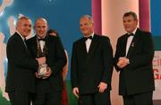 30 November 2001; Ollie Murphy of Meath receives his award from An Taoiseach Bertie Ahern TD, left, Paul Donovan, Chief Executive, Eircell Vodafone and Sean McCague, President, Cumann Luthchleas Gael, at the Eircell Vodafone All Star Awards at the CityWest Hotel, Dublin. Photo by Ray McManus/Sportsfile *EDI*
