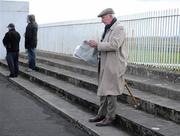 3 April 2011; A general view of a punter looking up the form during the days races. Horse Racing, Curragh Racecourse, Curragh, Co. Kildare. Picture credit: Barry Cregg / SPORTSFILE