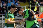 3 April 2011; Kerry physiotherapist John Sugrue affixes a bandage to the hand of Aidan O'Mahoney. Allianz Football League Division 1 Round 6, Monaghan v Kerry, Inniskeen, Co. Monaghan. Picture credit: Ray McManus / SPORTSFILE