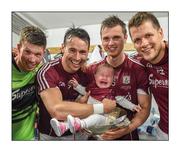 17 July 2016; Smiles and tears. Finian Hanley places his five-month-old daughter Freya in the Nestor Cup following Galway’s replay win over Roscommon. Gareth Bradshaw, Liam Silke and Johnny Heaney join the celebrations  Photo by Stephen McCarthy/Sportsfile  This image may be reproduced free of charge when used in conjunction with a review of the book &quot;A Season of Sundays 2016&quot;. All other usage © SPORTSFILE