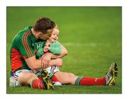 1 October 2016; Back to family. A dejected Andy Moran, left, plays with his daughter Charlotte on the pitch following All-Ireland defeat.  Photo by David Maher/Sportsfile  This image may be reproduced free of charge when used in conjunction with a review of the book &quot;A Season of Sundays 2016&quot;. All other usage © SPORTSFILE