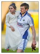 14 May 2016; Time for family. Laois defender Mark Timmons carries his nine-year-old daughter Kathlyn – boots ’n all – on her Communion Day after they had seen off Wicklow’s challenge  Picture credit: Matt Browne / SPORTSFILE  This image may be reproduced free of charge when used in conjunction with a review of the book &quot;A Season of Sundays 2016&quot;. All other usage © SPORTSFILE