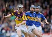 17 April 2011; Jim Berry, Wexford, in action against Eddie Connolly and Paddy Stapleton, right, Tipperary. Allianz Hurling League, Division 1, Round 7, Tipperary v Wexford, Semple Stadium, Thurles, Co. Tipperary. Picture credit: Brian Lawless / SPORTSFILE