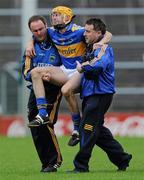 17 April 2011; Tipperary's Shane McGrath is helped from the pitch by Chartered Physiotherapist John Casey, left, and Dr. Peter Murchin. Allianz Hurling League, Division 1, Round 7, Tipperary v Wexford, Semple Stadium, Thurles, Co. Tipperary. Picture credit: Brian Lawless / SPORTSFILE