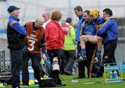 17 April 2011; Tipperary's Shane McGrath is helped from the pitch by Chartered Physiotherapist John Casey, left, and Dr. Peter Murchin. Allianz Hurling League, Division 1, Round 7, Tipperary v Wexford, Semple Stadium, Thurles, Co. Tipperary. Picture credit: Brian Lawless / SPORTSFILE