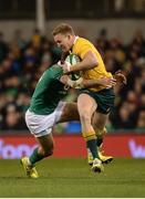 26 November 2016; Reece Hodge of Australia is tackled by Jared Payne of Ireland  during the Autumn International match between Ireland and Australia at the Aviva Stadium in Dublin. Photo by Cody Glenn/Sportsfile